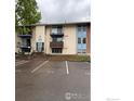 Exterior view of apartments building with private balconies and parking at 12172 Melody Dr # 101, Westminster, CO 80234