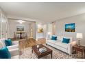 Bright living room and dining room with modern decor, hardwood flooring, and natural light at 12172 Melody Dr # 101, Westminster, CO 80234