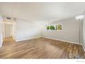 Large living room with new floors, fresh paint and lots of natural light at 12172 Melody Dr # 101, Westminster, CO 80234