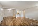 Spacious living room featuring hardwood floors and fresh gray paint at 12172 Melody Dr # 101, Westminster, CO 80234