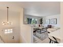 Bright living room features an open layout, large windows and modern decor, creating a welcoming atmosphere at 12802 E Nevada Cir, Aurora, CO 80012