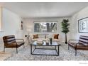 Bright living room with ample seating, modern decor, and plenty of natural light from a large window at 12802 E Nevada Cir, Aurora, CO 80012