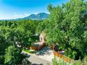Aerial view of a tree-lined neighborhood showcasing a charming home with mountain views at 1717 Iris Ave, Boulder, CO 80304