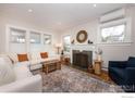 Bright living room featuring a cozy fireplace, large sofa, and mountain views at 1717 Iris Ave, Boulder, CO 80304