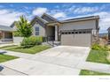 Inviting exterior of a single-Gathering home with a two-car garage, manicured lawn, and a welcoming front porch at 17871 E 96Th Pl, Commerce City, CO 80022
