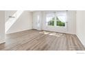 Sun-filled room featuring lots of natural light, new flooring, and large windows at 183 Lister Way, Erie, CO 80516