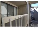 Private condo balcony with white railings overlooking trees and landscaping at 20 S Boulder Cir # 2204, Boulder, CO 80303