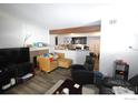 Open-concept living area with cozy furnishings, a fireplace, and an adjacent kitchen at 20 S Boulder Cir # 2204, Boulder, CO 80303