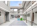 Inviting courtyard with vibrant Adirondack chairs and a walkway between condo units at 2201 Pearl St # 110, Boulder, CO 80302