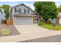 Charming two-story home featuring a two-car garage, stone accents, and a well-manicured front lawn in a suburban neighborhood at 2232 S Yampa Ct, Aurora, CO 80013