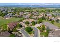 Expansive aerial view of the neighborhood featuring lush greenery and mountain views at 2378 Plumb Pl, Erie, CO 80516