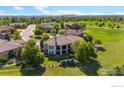 Lovely rear exterior featuring a backyard with lush landscaping and manicured lawn at 2378 Plumb Pl, Erie, CO 80516