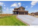 Charming two-story home with a three car garage, stone accents, landscaping and large driveway at 250 Chardon Ave, Brighton, CO 80601