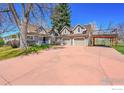 View of the home's three-car garage and outdoor deck with stairs leading to the yard at 2994 75Th St, Boulder, CO 80301