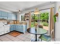 Cozy kitchen featuring light blue cabinetry, stainless steel appliances, and a breakfast nook with outdoor access at 309 27Th St, Boulder, CO 80305
