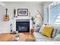 Bright living room with a decorative fireplace, hardwood floors, and ample natural light at 309 27Th St, Boulder, CO 80305