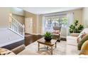 Bright living room features hardwood floors, staircase, and large window at 3124 Marlin Dr, Longmont, CO 80503