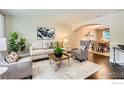 Comfortable living room with neutral tones, stylish furniture, and view into dining area at 3124 Marlin Dr, Longmont, CO 80503