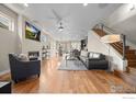 Bright living room with a cozy fireplace, hardwood floors, and open layout leading to the dining area and kitchen at 3845 N Raleigh St, Denver, CO 80212