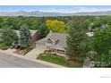 Expansive aerial shot of home with mature trees and mountain views at 4483 S Meadow Dr, Boulder, CO 80301