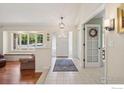 Open foyer with tile flooring, bench seating, large windows, and a view into other rooms at 4483 S Meadow Dr, Boulder, CO 80301