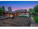 Extensive backyard features garden space, storage building, and solar panels for energy efficiency at 4900 W 6Th Ave, Denver, CO 80204