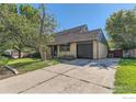 Single-story home featuring a large driveway, attached garage, and mature landscaping at 510 S 46Th St, Boulder, CO 80305