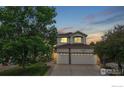 Charming two-story home featuring a three-car garage and landscaped front yard at 7597 Bison Ct, Littleton, CO 80125