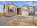 Charming single Gathering home featuring stone accents, two-car garage, and neutral colored siding at 874 Ledge St, Lochbuie, CO 80601