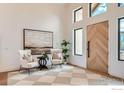 Airy entrance featuring soaring ceilings, tile floors and an elegant wooden door at 1126 W Enclave Cir, Louisville, CO 80027