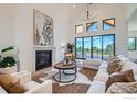 Open concept living room featuring a fireplace, vaulted ceilings and natural light at 1126 W Enclave Cir, Louisville, CO 80027
