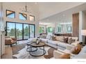 Bright living room with high ceilings, expansive windows, and comfortable seating for relaxing and entertaining at 1126 W Enclave Cir, Louisville, CO 80027