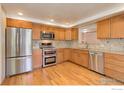 Modern kitchen features stainless steel appliances, wooden cabinets, and beautiful countertops at 1133 Frontier Dr, Longmont, CO 80501