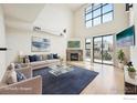 Bright living room with vaulted ceilings, large windows, and a cozy fireplace at 1200 Yarmouth Ave # 237, Boulder, CO 80304