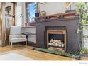 Comfortable living room area with a classic fireplace with white logs and sleek hardwood floors at 1217 N Downing St # 4, Denver, CO 80218