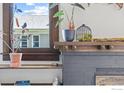 Intricate fireplace features gray brickwork, a wooden mantle, and accents of greenery throughout at 1217 N Downing St # 4, Denver, CO 80218