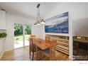 Light-filled dining area with a view of the backyard and an artistic decor at 137 S Polk Ave, Louisville, CO 80027