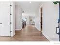 Open foyer with hardwood floors, leading to staircase and living room, offering a glimpse of the home's layout at 1426 Swan Peter Dr, Berthoud, CO 80513