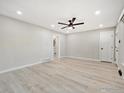 Living room with light wood flooring, ceiling fan, and white trim at 1475 S Eaton St, Lakewood, CO 80232