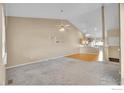 Spacious living room featuring vaulted ceilings, carpeted floors, and an open layout at 2156 Collyer St, Longmont, CO 80501