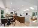 Bright and open kitchen and dining area featuring modern appliances and sleek finishes at 268 S Buchanan Cir, Louisville, CO 80027