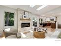 Bright living room with a stone fireplace, hardwood floors, and an open floor plan at 268 S Buchanan Cir, Louisville, CO 80027