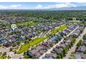 Wonderful aerial view of the neighborhood with green spaces, community pool, and mountain views at 2830 Cascade Creek Dr, Lafayette, CO 80026