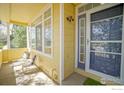 Cozy front porch with seating area and charming blue trimmed door featuring a security screen at 2855 Rock Creek Cir # 233, Superior, CO 80027
