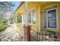 Inviting front porch with brick accents and sunny yellow trim, number 2333 is affixed to the column at 2855 Rock Creek Cir # 233, Superior, CO 80027