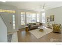 Bright and airy living room with hardwood floors, large windows, and modern furnishings at 2855 Rock Creek Cir # 233, Superior, CO 80027