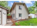 Two-story home featuring neutral paint, manicured lawn, and fenced yard at 32 Powder Horn Pl, Longmont, CO 80504