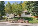 Home exterior featuring mature trees, brick landscaping, and an attached garage at 3635 Buckeye Ct, Boulder, CO 80304