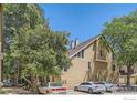 Multi-level home with multiple cars in the driveway and mature landscaping at 4771 White Rock Cir # B, Boulder, CO 80301