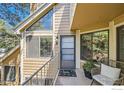 Inviting front porch with a sitting chair and a triangular window at 4771 White Rock Cir # B, Boulder, CO 80301